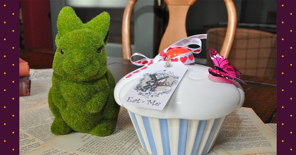 alice in wonderland birthday party with grass rabbit and oversized sweet jar